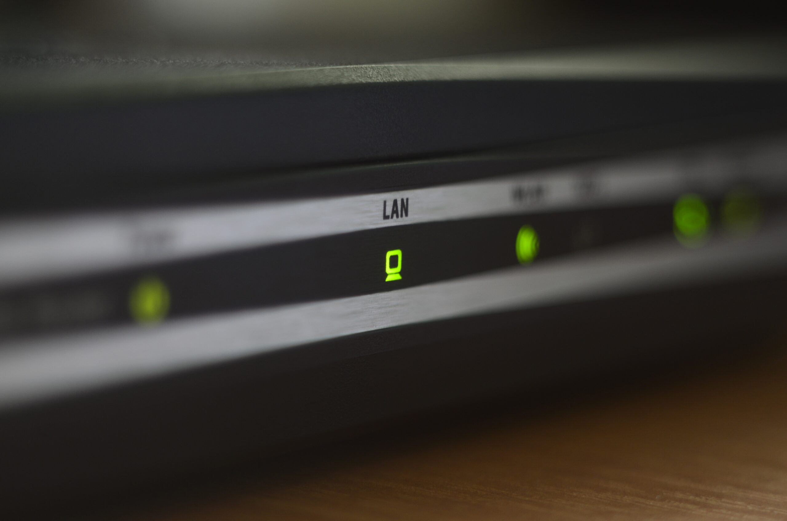 Macro of internet modem, abstract technology background. Green "LAN" indicator on internet router