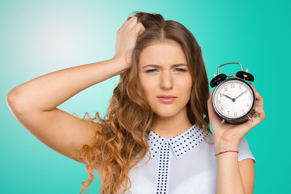 Businesswoman with clock being late for her deliverables