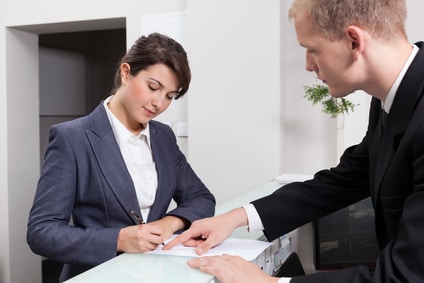 Businesswoman signing document Horizontal view of attractive businesswoman signing document