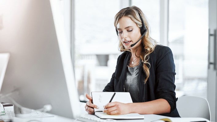 I'll make an extra reminder about that Shot of a young woman using a headset and computer at her desk in a modern office