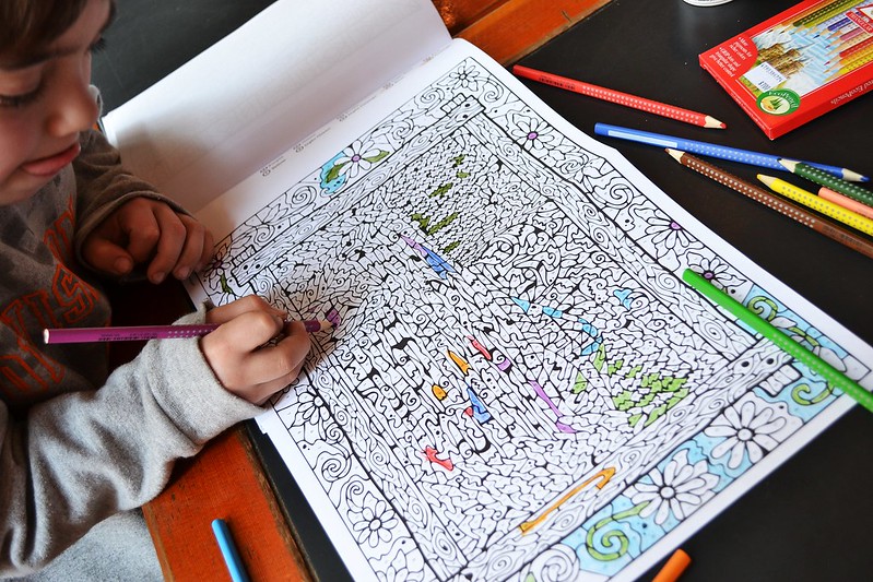 A child is drawing something on drawing book A child is drawing something on drawing book