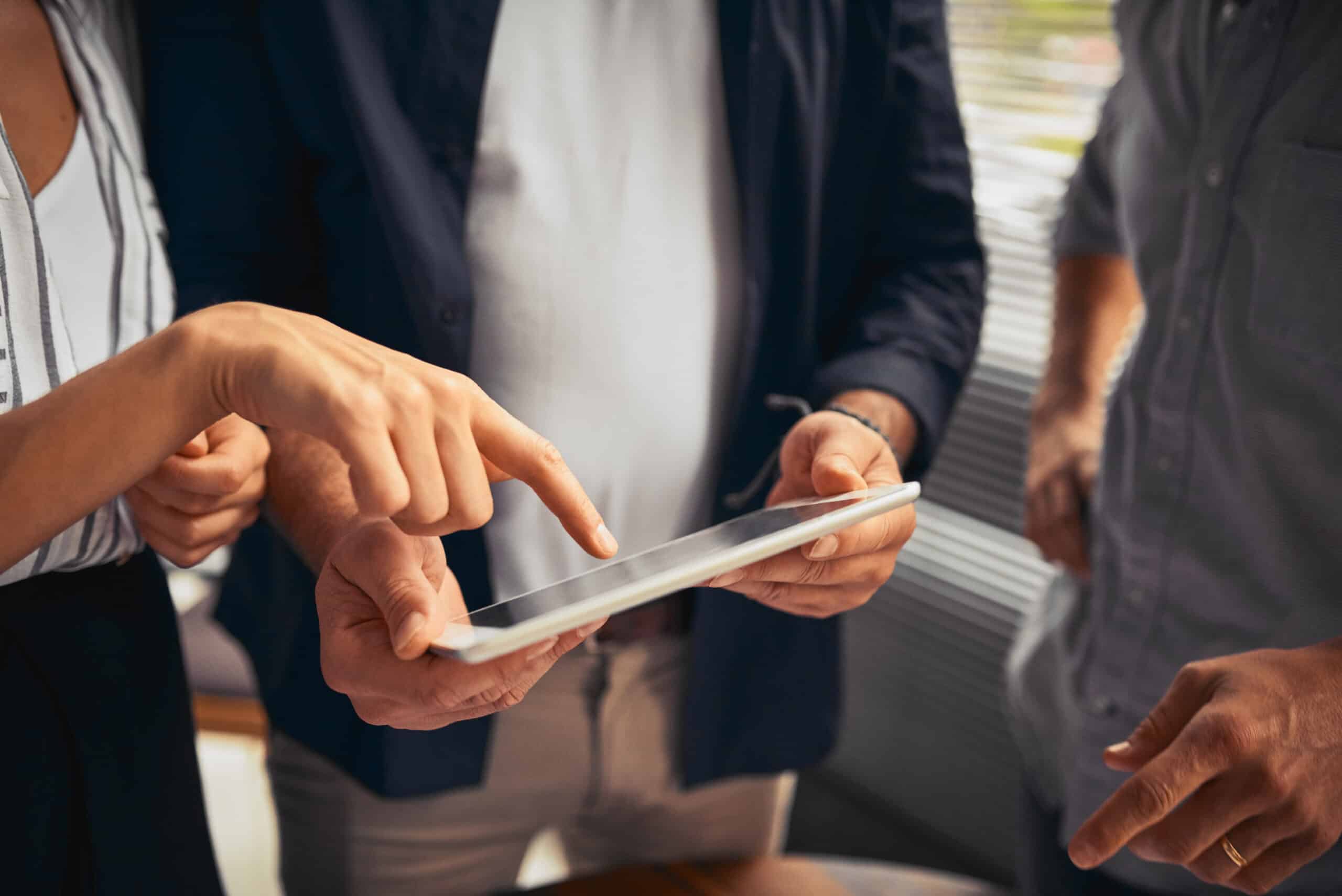 Cropped shot of unrecognizable businesspeople working together and using a tablet in the office.